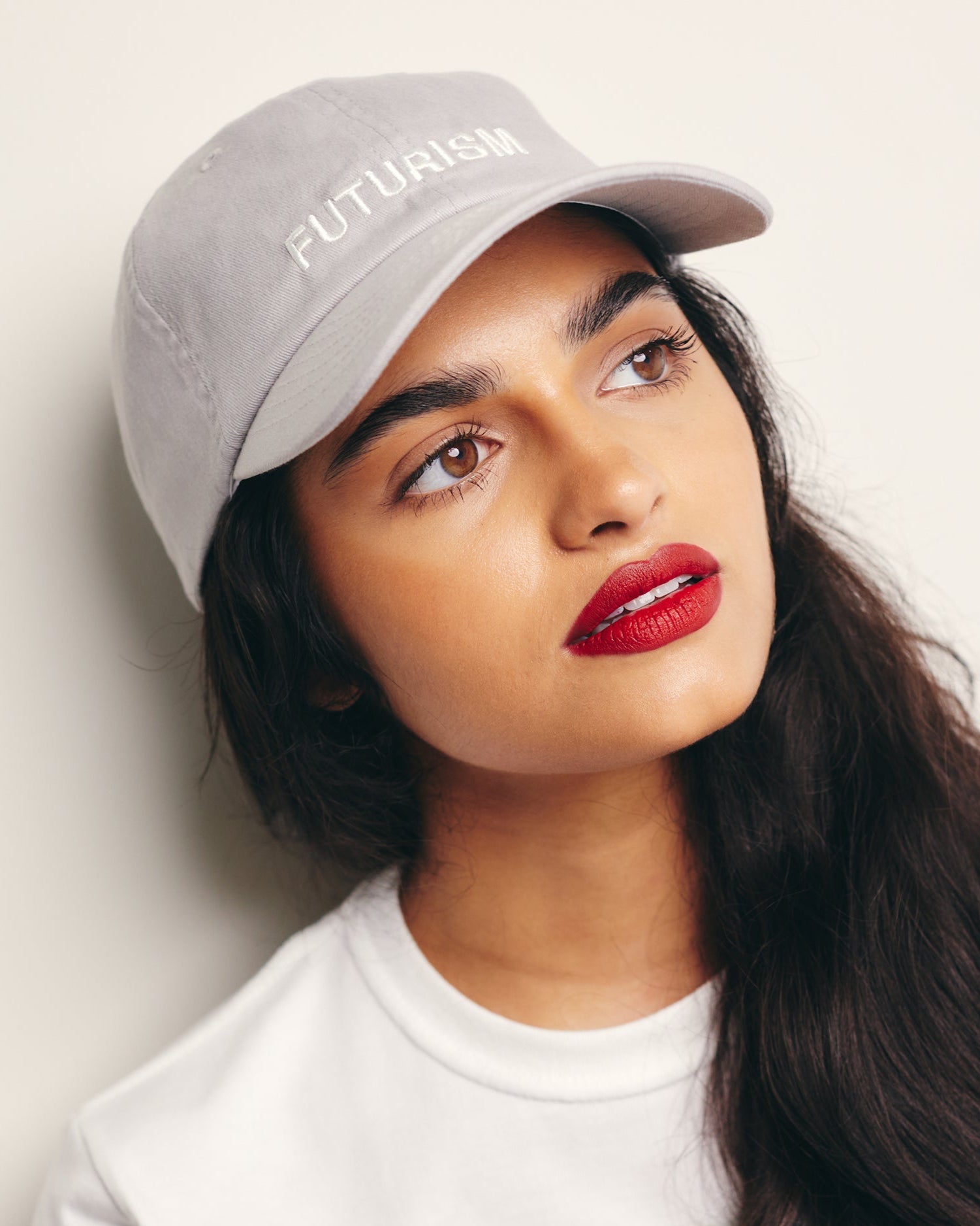 Mira Bhat wears Futurism Gray Baseball Cap / Dad Hat with Futurism Art Movement Text Embroidery on Front. 100% Cotton.